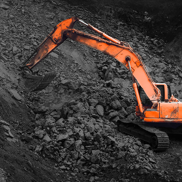 An excavator smashing the rocks to pulp.